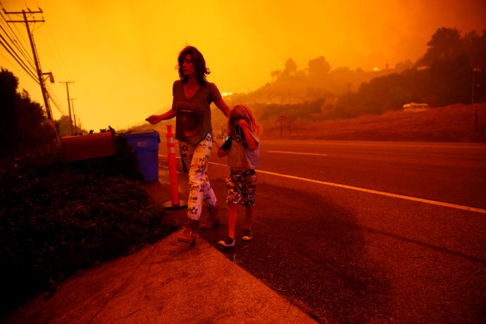 Matka se synem Gabi a Jonah Frankovi utíkají před požáry pěšky po dálnici Pacific Coast, protože jejich domov ve městě Malibu je v ohrožení. Foto: Eric Thayeer, Reuters
