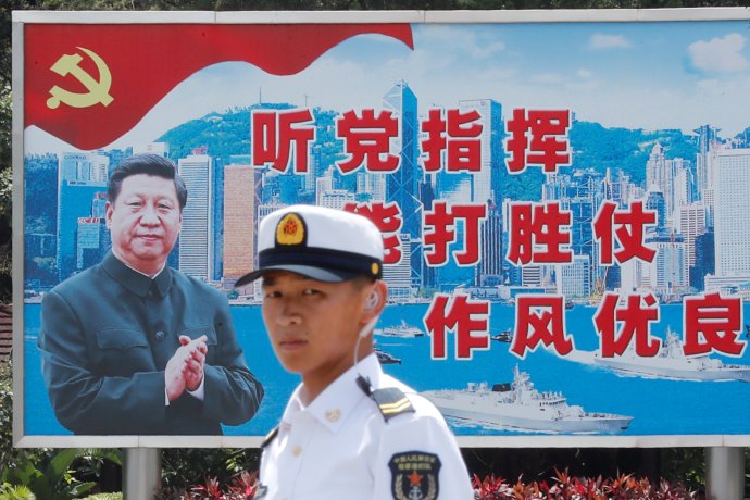 Příslušník čínské armády v Hongkongu, na pozadí Si Ťin-pching. Foto: Tyrone Siu, Reuters