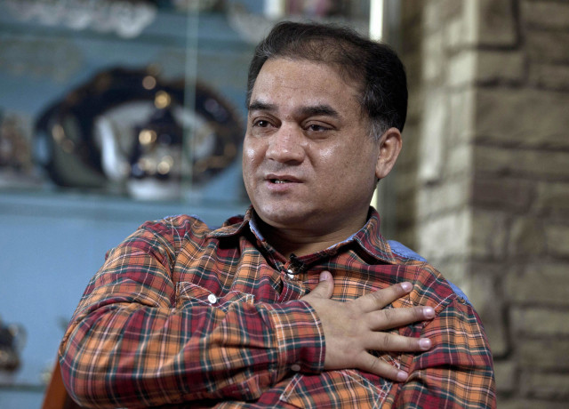 Ilham Tohti na smínku z února 2013. Foto: Andy Wong, AP, ČTK