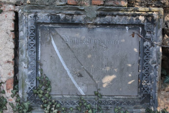 Náhrobní deska ve zdi bývalého bubenečského hřbitova. Foto: Michael Švec, Deník N