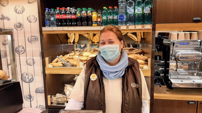 Prodavačka v malém pekařství ve stanici metra Kobylisy. Každá vděčnost, kterou lidem za pulty obchodů či u pokladen supermarketů projevíme, je nesmírně potěší. Zaslouží si ji. Foto: Jan Moláček, Deník N