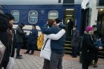 The couple says goodbye in front of the train that goes from Mariupol to Kyiva. When people hear that checkpoints are closed and they cannot leave Mariupol, they decide to go by train. 