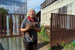 Klaudia (68) holds her sick cat. Volunteers from Piatykhatky will take her cat to Kharkiv to vet. Klaudia never left her house. She witnesses full Russian occupation. She lives just three and half km from the Russian border.