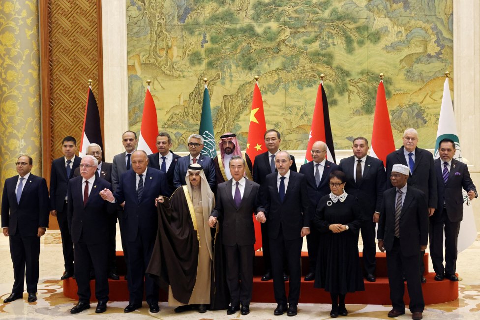 Čínský ministr zahraničí Wang I se účastní skupinového focení se svými protějšky z islámské diplomatické delegace: Fajsalem bin Farhánem Saúdem (Saúdská Arábie), Ajmánem Safádím (Jordánsko), Sámehem Šukrím (Egypt), Retno Marsudi (Indonésie), Rijádem al-Málikím (Palestina). Členem delegace byl i generální tajemník Organizace islámské spolupráce Hissein Brahím Taha (v bílé čapce vpravo). Foto: Florence Lo, Reuters
