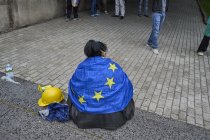 A protester wrapped in a European flag with a construction helmet near her before the protest against Foreign Influence Act. Young people have been organizing demonstrations for 14 days. They have experience with the police, who intervened harshly in their protests against using rubber bullets, gas and water cannons. Dozens of protestors ended up in hospitals.